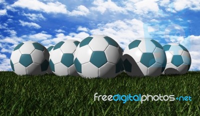 Cyan Soccer Balls On A Green Grass Stock Image