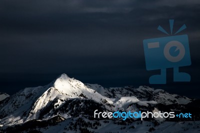 Dark Clouds With White Mountains Stock Photo