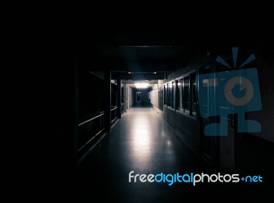 Dark Corridor Of The Building - Light Shining From The End Stock Photo