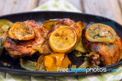 Delicious Baked Chicken Thighs With Lemon Slices, Onion And Zucchini Stock Photo