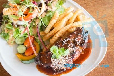 Delicious Barbecued Ribs With Spicy Sauce And Organic Salad Stock Photo