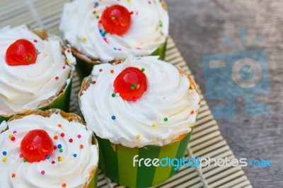 Delicious Cupcake On The Wooden Floor Stock Photo