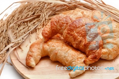 Delicious Fresh Croissants With Rice On Wooden Background Stock Photo