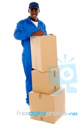Delivery Boy Writing On Clipboard Stock Photo