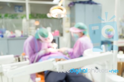 Dentist And Dental Assistants In Hospital ( Blurry Dental Background ) In Thailand Stock Photo