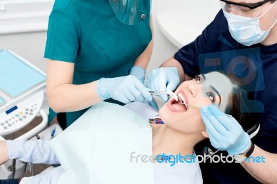 Dentist Cleaning A Patient Teeth Stock Photo