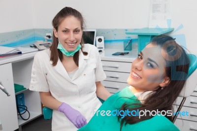 Dentist Examining A Patient's Teeth In The Dentist Stock Photo