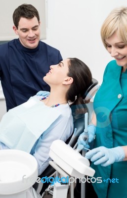 Dentist Explaining Teeth Model To Patient Stock Photo