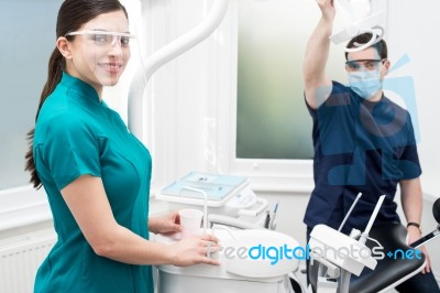 Dentist Setting Up Equipments In Clinic Stock Photo