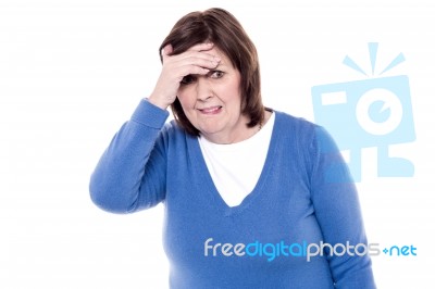 Depressed Woman Touching Her Forehead Stock Photo