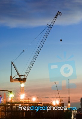 Derrick Cranes At Construction Site Stock Photo