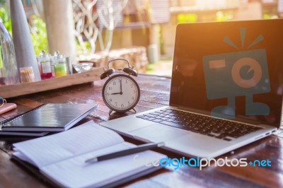 Desktop Mix Of Office Supplies And Gadgets . Desk With Laptop , Smart Phone, Glasses , Watch , Notebook , Tablet, On A Wood Table Stock Photo