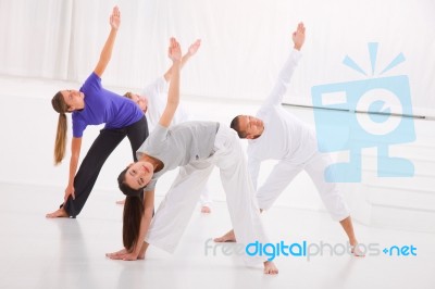 Diverse Group Of People Practicing Yoga In Fitness Studio Stock Photo