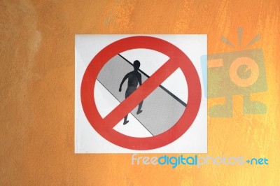 Do Not Cross Symbol On Orange Wall Stock Photo