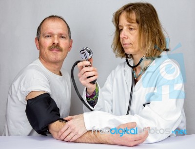 Doctor Checks Blood Pressure Of A Patient Stock Photo