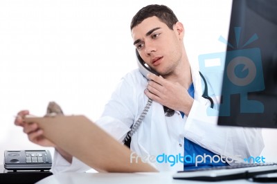 Doctor Convey His Notes To Others Over Phone Stock Photo