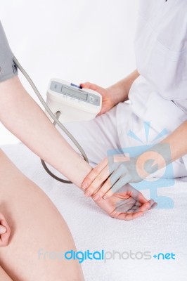 Doctor Gets Measure The Pressure To Woman Patient Stock Photo