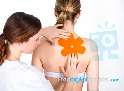Doctor Gets Tapes On Patient Back Stock Photo
