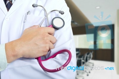 Doctor Holding Stethoscope Stock Photo