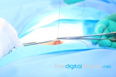 Doctor Suturing Open Wound Stock Photo