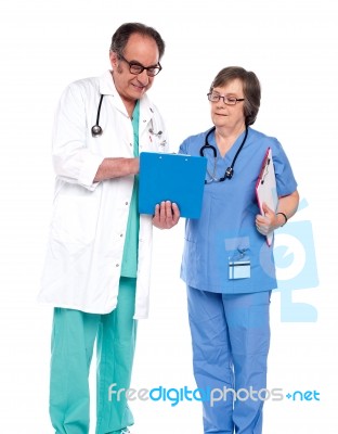 Doctors Discussing Medical Report Stock Photo