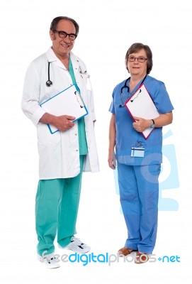 Doctors Holding Clipboard On White Stock Photo