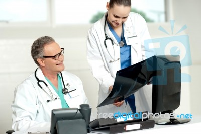 Doctors Reviewing X ray Report Stock Photo