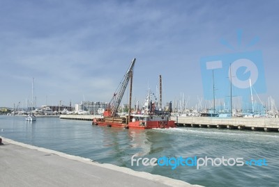 Dredger Coming Into Rimini Port Stock Photo