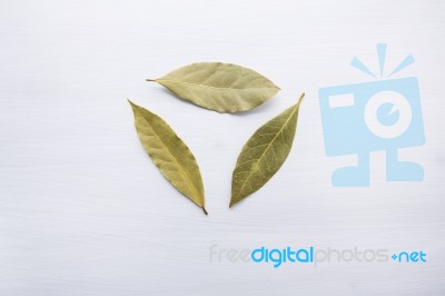 Dried Bay Leaves On White Wooden Background Stock Photo