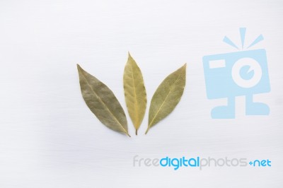 Dried Bay Leaves On White Wooden Background Stock Photo