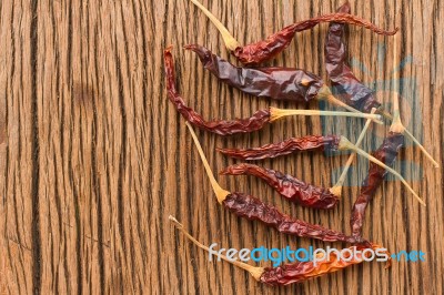 Dried Chili Pepper On Wooden Table Stock Photo