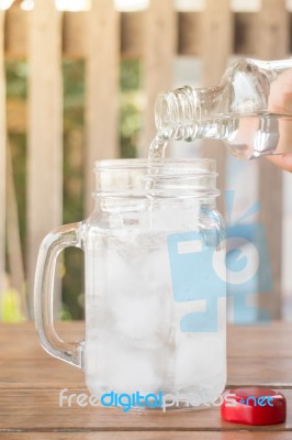 Drinking Water Is Poured Into Iced Glass Stock Photo