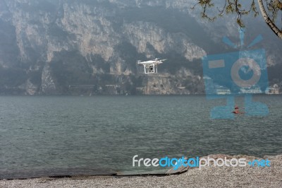 Drone Hovering On The Shoreline At Riva Del Garda Stock Photo