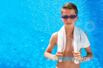 Dutch Teenage Boy Wearing Swimming Goggles And Towel At Swimming… Stock Photo