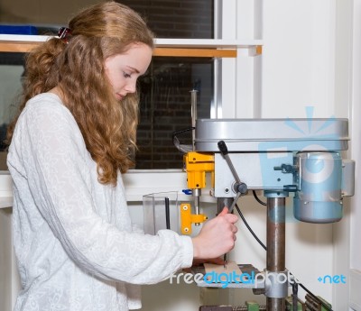 Dutch Teenage Girl Operating Electric Drilling Machine Stock Photo