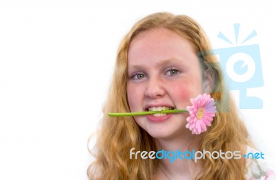 Dutch Teenage Girl With Pink Flower In Mouth Stock Photo