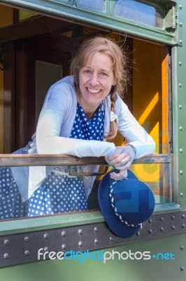 Dutch Woman In Old-fashioned Clothes Holding Hat In Train Window… Stock Photo
