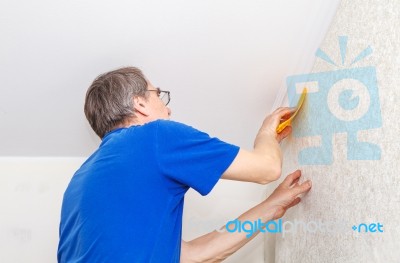 Elderly Worker Smoothing Wallpaper Stock Photo