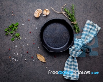 Empty Old Cast Iron Skille On Dark Stone Background. Ingredients… Stock Photo