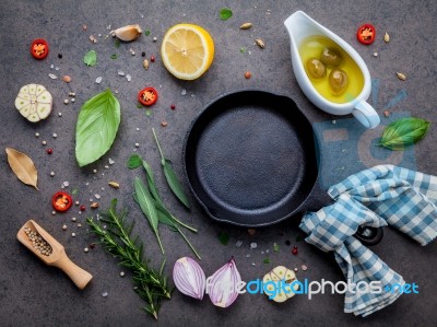 Empty Old Cast Iron Skille On Dark Stone Background. Ingredients… Stock Photo