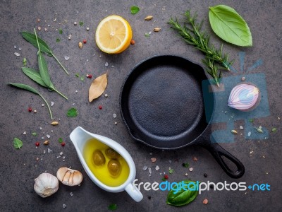 Empty Old Cast Iron Skille On Dark Stone Background. Ingredients… Stock Photo