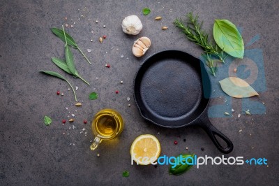 Empty Old Cast Iron Skille On Dark Stone Background. Ingredients… Stock Photo