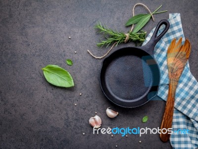 Empty Old Cast Iron Skille On Dark Stone Background. Ingredients… Stock Photo