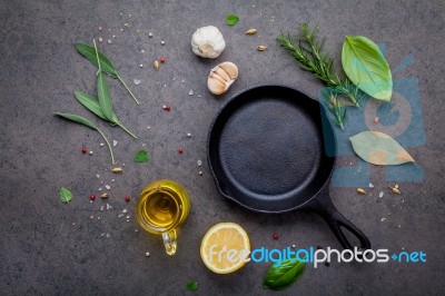 Empty Old Cast Iron Skille On Dark Stone Background. Ingredients… Stock Photo