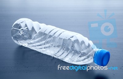 Empty Plastic Bottle Lying On Gray Background Stock Photo