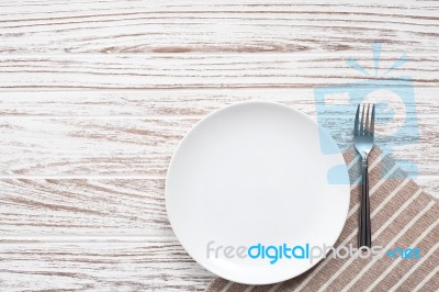 Empty Plate Napkin Fork Silverware White Wooden Table Background… Stock Photo