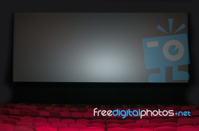 Empty Seat On Row In Thearter With Movie Screen Stock Photo