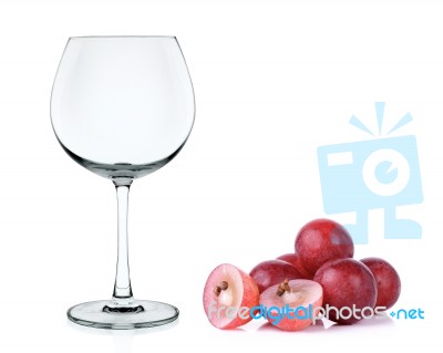 Empty Wine Glass With Red Grape Isolated Stock Photo