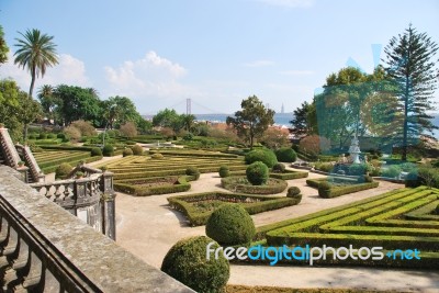 Enchanted Ajuda Garden With April 25th Bridge In Lisbon, Portugal Stock Photo