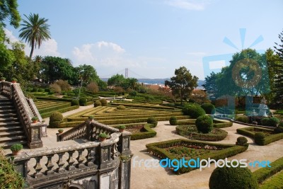 Enchanted Ajuda Garden With April 25th Bridge In Lisbon, Portugal Stock Photo